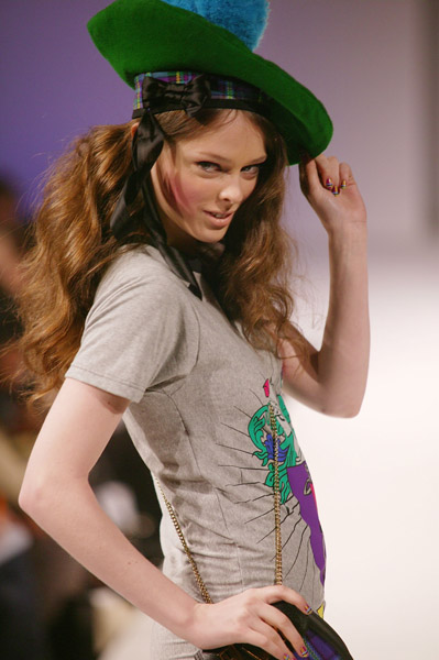 model wearing green hat