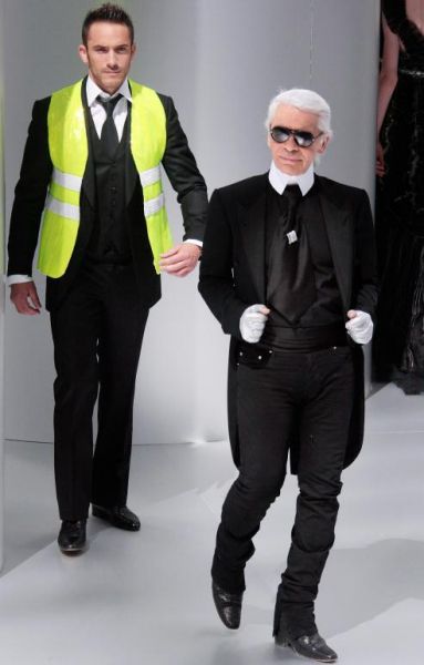 German fashion designer Karl Lagerfeld posing with a reflective vest to promote its wear