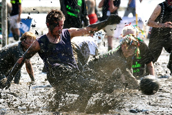 participants plays soccer in the mud flats of the Elbe River