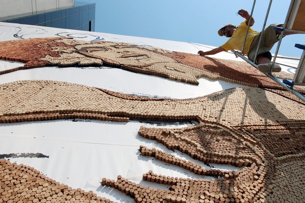 Saimir Strati, 42, works on The Guitarist mosaic using cork 
