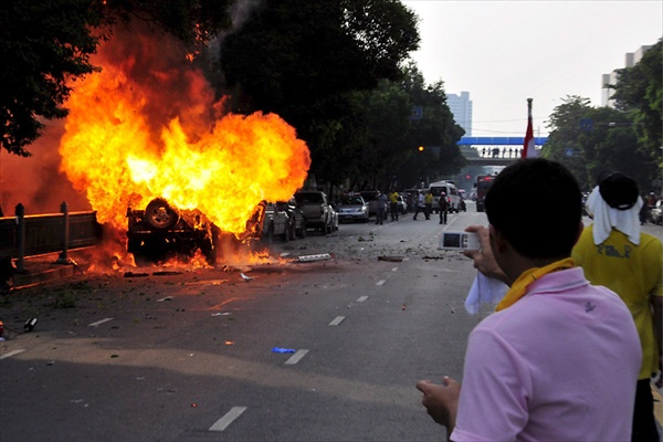 policemen fire tear gas to disperse anti-government protesters in Bangkok