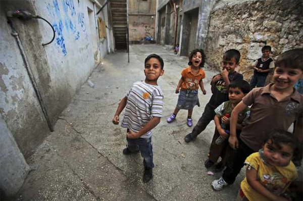 Палестинский мальчик прикидывается бодибилдером во время игры с товарищами
